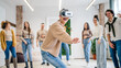 © Miljan Živković - One woman in front group of friends enjoy virtual reality VR headset