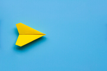 Wall Mural - Top view of single yellow paper airplane with customizable space for text.