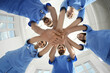 © New Africa - Young doctors stacking hands together indoors, bottom view