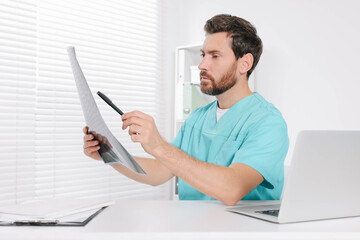 Doctor examining neck MRI scan in hospital