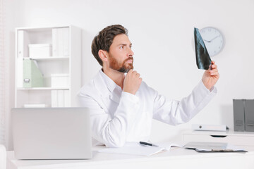 Doctor examining neck MRI scan in hospital