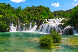 Fototapeta Łazienka - Beautiful Waterfall background in sunny summer day. Beautiful Waterfall In Krka National Park - Croatia, Europe. Krka river waterfalls in the Krka National Park