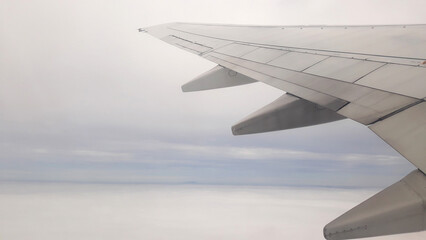 Canvas Print - Airplane wings flying in the sky.