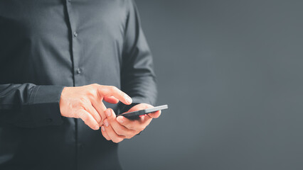 Poster - Man viewing website social network connecting with wifi in home by mobile phone. Male hands holding a smartphone model touching sensor screen to browse internet. Concept of Virtual communication.