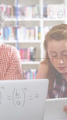 Poster - animation of mathematical equations over male teacher and school children using laptop in classroom