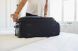 © Astrakan Images - Midsection of woman packing suitcase