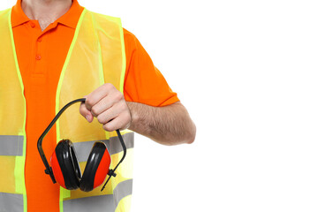 Wall Mural - Civil engineer holds protective ear muffs, isolated on white background