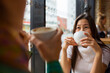 © Astrakan Images - Two women drinking coffee in cafe