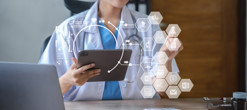 Doctor work on digital tablet healthcare doctor technology tablet using computer in a modern office  in the morning at the desk.