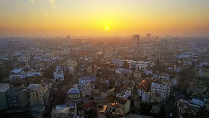 Wall Mural - Aerial drone view of Bucharest at sunset, Romania. Multiple residential buildings, fog in the air