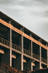 Sticker - Vertical shot of an empty building with yellow railings under construction