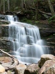 Sticker - a waterfall with rocks and water in the middle of it