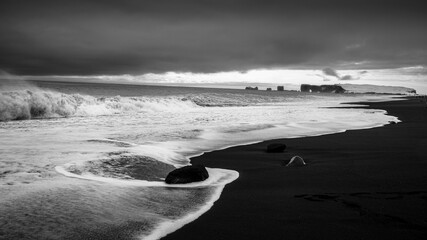 Poster - Powerful waves rolling onto a beach near rugged cliffs