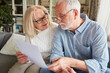 © Robert Kneschke - Senior couple reading retirement plan contract at home