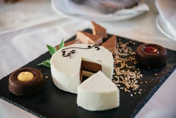 Wall Mural - Closeup of a white cake stuffed with chocolate on a tray at a banquet