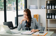 © Nuttapong punna - Asian businesswoman working in the office with working notepad, tablet and laptop documents .