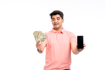 Young indian man showing indian currency and smartphone screen.