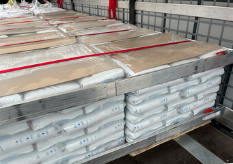 Wall Mural - loading, transportation and unloading of bulk materials in bags of 25 kilograms in a semi-trailer. s