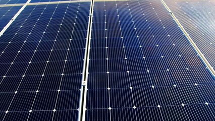 Wall Mural - Aerial drone view of multiple solar panels on the roof of a manufacturing building. Ecology thematics