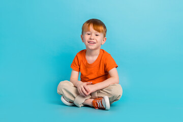 Portrait of glad charming boy rejoice good mood comfort modern outfit isolated on cyan color background