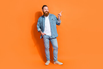 Wall Mural - Full body photo of business entrepreneur hipster irish man wear denim clothes look direct finger mockup startup isolated on orange color background