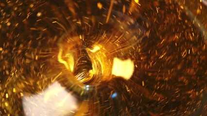 Poster - Abstraction of a fast swirling whirlpool in golden liquid going into deep with a reflection on its surface with a lot of particles inside. Abstract motion design on a glowing background