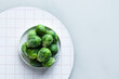 © Austockphoto - brussels sprouts in a white dish with copyspace