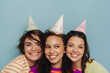 © Drobot Dean - Three cheerful girls smiling while posing isolated over blue background
