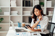 © Tj - Young Asian Businesswomen smiling and happy used laptop working in the office.