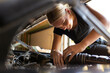 © Austockphoto - young australian tradesperson mechanic fixing car engine in automotive repair garage