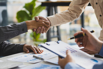 Meeting of business people, financial advisors shaking hands.