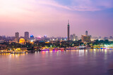 View of Nile river with El Gezira, zamalek, cairo tower and towers illuminated at night