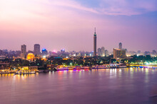 View Of Nile River With El Gezira, Zamalek, Cairo Tower And Towers Illuminated At Night