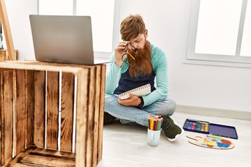 Sticker - Young redhead man having online draw class at art studio