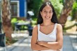 © Krakenimages.com - Young beautiful hispanic woman standing with arms crossed gesture at park