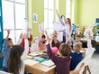 © Krakenimages.com - Woman and group of kids having recycling lesson holding empty bottle at classroom