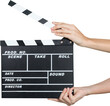 © BillionPhotos.com - Human Hands Holding a Movie Clapboard - Isolated