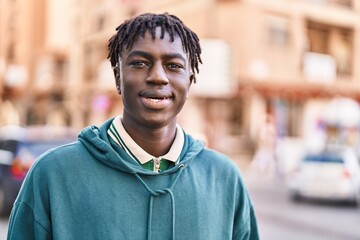 Wall Mural - African american man smiling confident standing at street