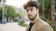 © Krakenimages.com - Young hispanic man standing with serious expression at street