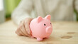 © Krakenimages.com - Young hispanic man holding piggy bank on table