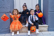 © Krakenimages.com - Group of kids wearing halloween costume holding pumpkin basket at street