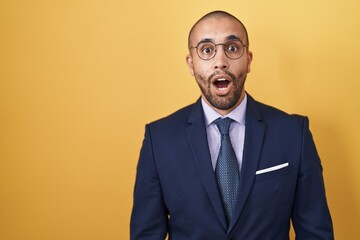 Canvas Print - Hispanic man with beard wearing suit and tie afraid and shocked with surprise expression, fear and excited face.