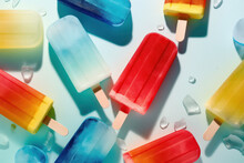 Summer Creative Tropical Background, Flat Lay Of Icy Exotic Refreshment, Colorful, Vivid Color Ice Creams On Stick On Pastel Blue Background. Generative AI.