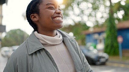 Wall Mural - African american woman smiling confident looking to the side at street