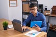 © Krakenimages.com - Young hispanic man business worker using touchpad and laptop at office