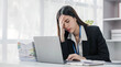 © wichayada - asian woman thinking hard concerned about online problem solution looking at laptop screen, worried serious asian businesswoman focused on solving difficult work computer task.