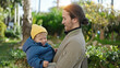 © Krakenimages.com - Father and son smiling confident hugging each other at park