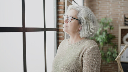 Poster - Middle age woman with grey hair business worker standing with relaxed expression at office