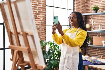 Wall Mural - African american woman artist make picture by the smartphone to draw at art studio