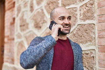 Sticker - Young man smiling confident talking on the smartphone at street